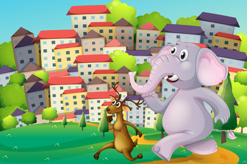 A deer and an elephant running at the hilltop across the tall bu