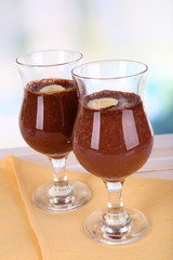 Cocktails with banana and chocolate on table on light