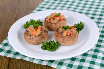 Stuffed mushrooms on plate on table close-up