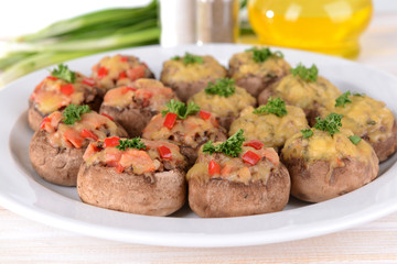 Stuffed mushrooms on plate on table close-up