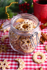 Fototapeta na wymiar Delicious Christmas cookies in jar on table close-up