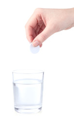 Glass with efervescent tablet in water with bubbles isolated