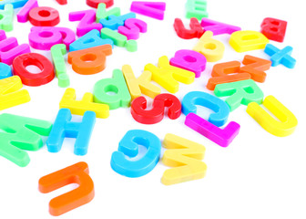Fototapeta premium Colorful magnetic letters isolated on white
