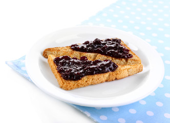 Delicious toast with jam on plate isolated on white
