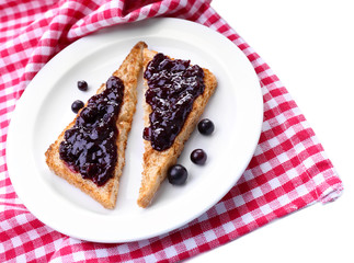 Delicious toast with jam on plate close-up