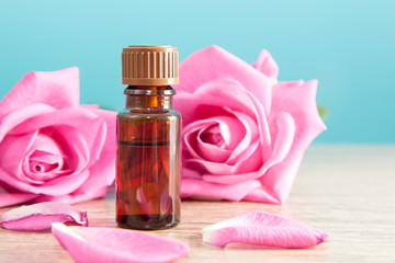 Bottle with aromatic oil and pink rose