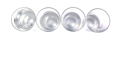 Water filled glasses over white background