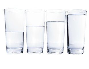 Water filled glasses over white background