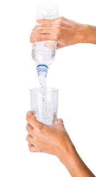 Female hands pouring water into a glass
