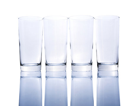 Row of empty glasses over white background