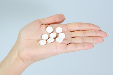 white pills in her hand