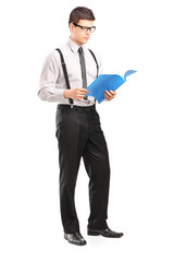 Full length portrait of young man reading papers
