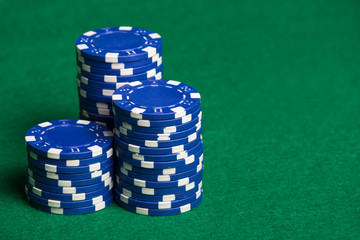 blue poker chips on the green table