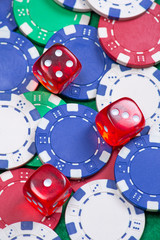 poker chips and dice on the green table