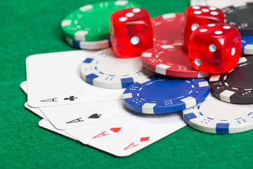 playing poker chips, dice and cards on the green table