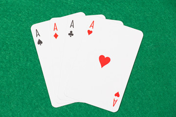 playing cards - aces on green table