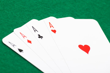playing cards - four aces on green table