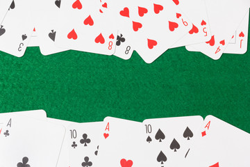 close up of playing cards on the green table