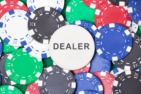 close up of colorful poker chips and big dealer chip