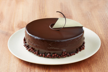 Whole chocolate cake on a dish