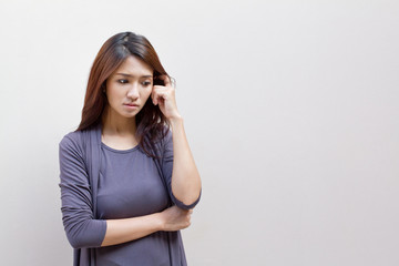 thinking woman, facing upward on plain background