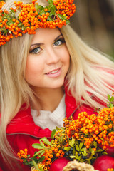 Portrait of smiling beautiful woman wreath of berries in autumn