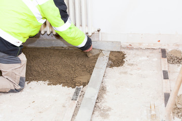 mason building a cement screed