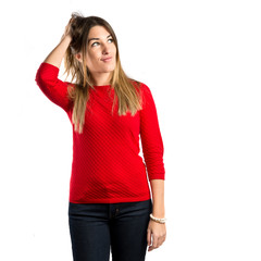 Young girl thinking over isolated white background