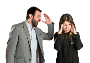 Businessman screaming at his girlfriend over white background