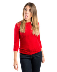 Fototapeta premium Young girl doing a joke over isolated white background