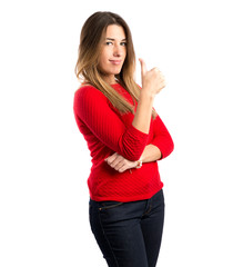 Young woman making Ok sign over white background