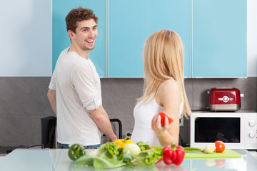Young beautiful couple cooking at home