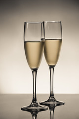 empty glasses of champagne and one being filled 