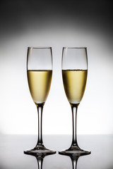 empty glasses of champagne and one being filled 