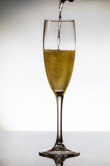 empty glasses of champagne and one being filled 