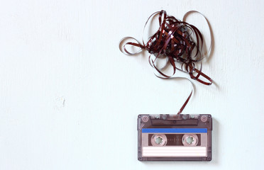 Audio cassette tape with subtracted out tape over blue textured 