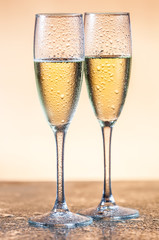 empty glasses of champagne and one being filled 