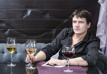 young man holds wine tasting in the restaurant