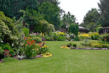 Green lawn in a colorful landscape formal garden.