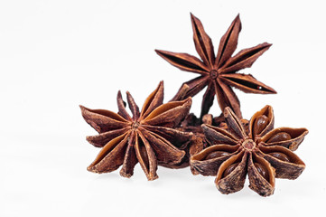 Cinnamon, anise and cloves on white background