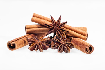 Cinnamon, anise and cloves on white background