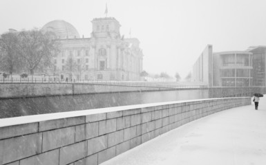Winter in Berlin with walking People and The Reichstag building