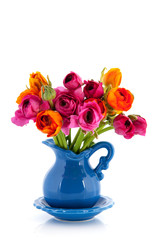 Colorful bouquet butter cups in blue vase