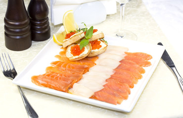 cutting of the fish on the table in a restaurant