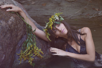 Young beautiful sad woman in the water