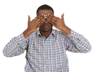 Man covering eyes with hands can't see. See no evil concept.