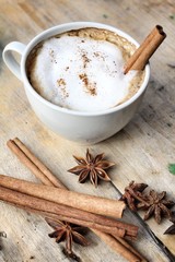 Obraz na płótnie Canvas hot cappuccino with spices cinnamon sticks and star anise.