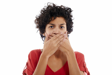 Fototapeta na wymiar sad hispanic woman with hands on mouth