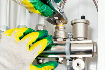 Worker hands fixing heating system