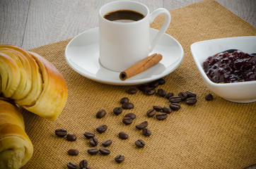 Cup of black coffee and croissant